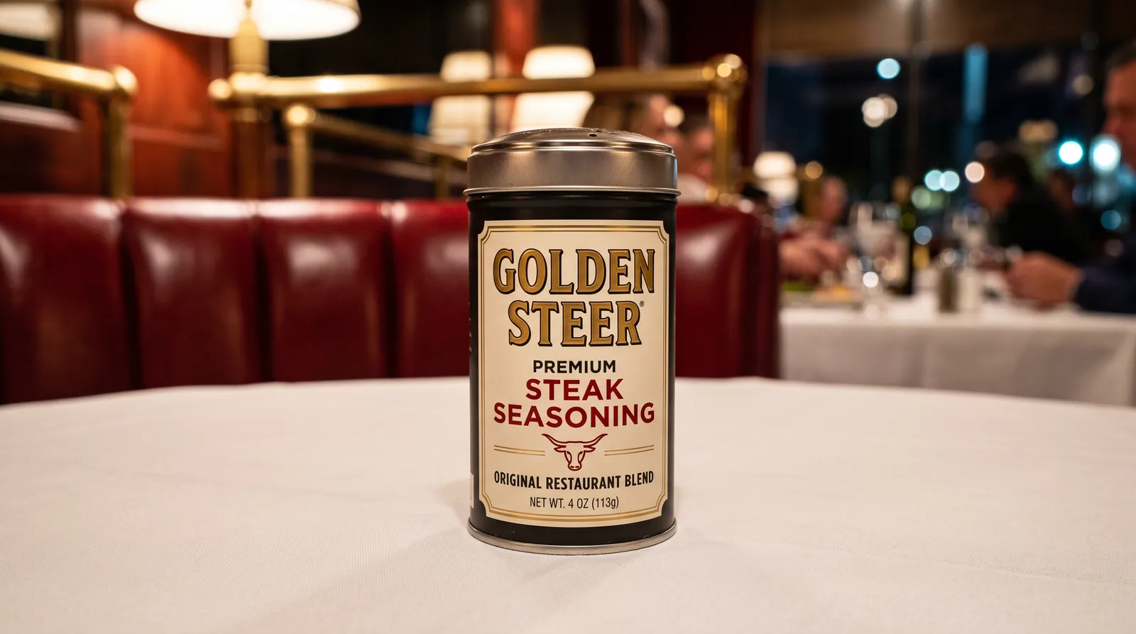 Close-up of a Golden Steer premium steak seasoning tin on a white tablecloth